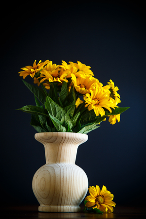 bouquet of yellow big daisies on a black backgroundの写真素材