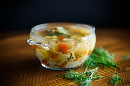 chicken soup with homemade noodles in a plateの写真素材
