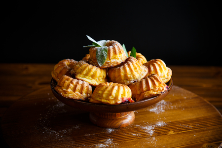 sweet muffin curd in sugar powder on the tableの写真素材