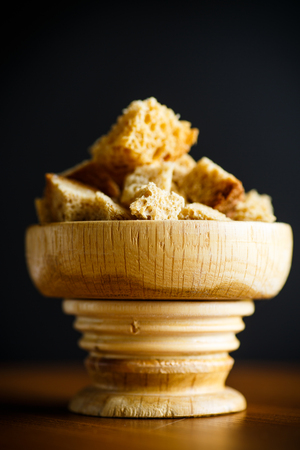 home bread crumbs in a wooden cup on the tableの写真素材