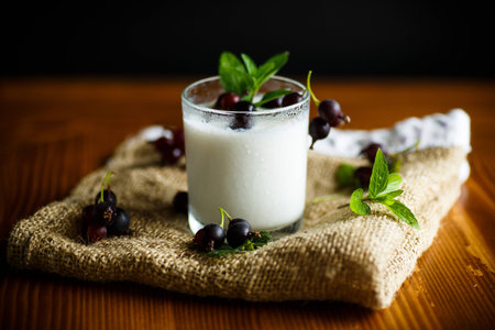 sweet homemade yogurt with black currant in a glassの写真素材