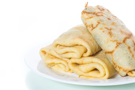 fried thin pancakes stuffed on a plate isolated on a white backgroundの写真素材