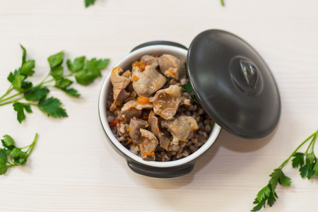 stewed chicken stomachs with vegetables and buckwheat in a bowlの写真素材