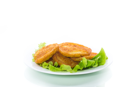 potato pancakes with lettuce leaves in a plateの写真素材