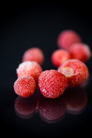fresh frozen red ripe strawberries on a blackの写真素材