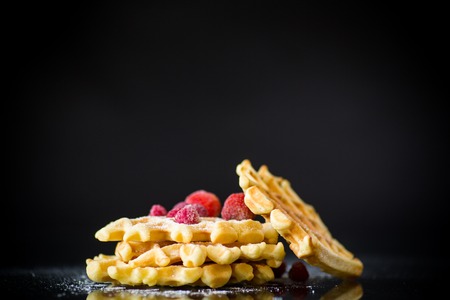 cooked sweet Viennese waffles on a black backgroundの写真素材