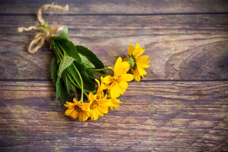 bouquet of beautiful blooming daisies on a wooden tableの写真素材