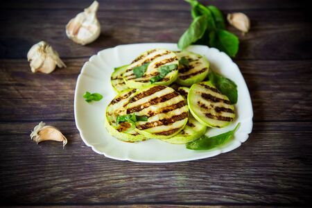 grilled zucchini slices with garlic and spicesの写真素材