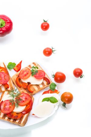 Closeup of a fresh sandwich with mozzarella, tomatoes , on a white background.の写真素材