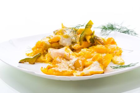 fried omelet from homemade eggs with sweet yellow pepper in a plate isolated on a white background.の写真素材