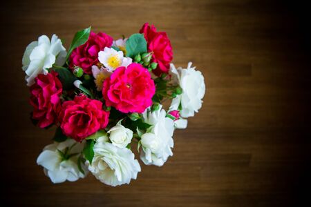 bouquet of beautiful red and white roses on a woodenの写真素材