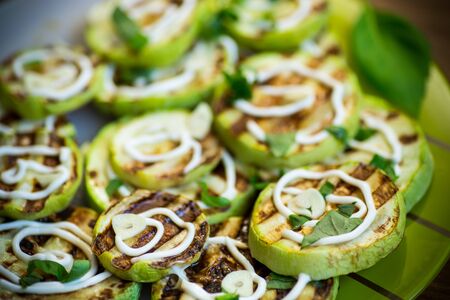 grilled zucchini slices with garlic and spicesの写真素材