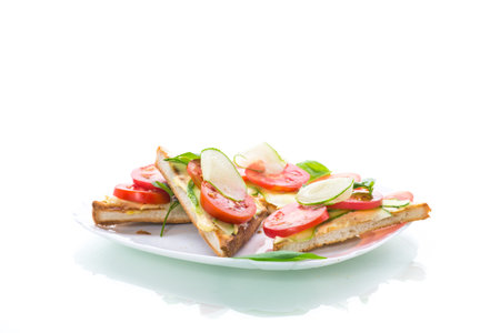 tasty sandwich with curd paste, fresh cucumbers and tomatoes on a white backgroundの写真素材