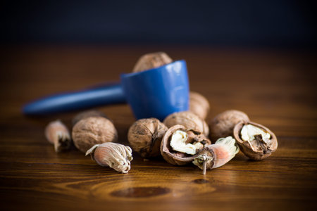 organic natural walnuts and nut cracker on a wooden table