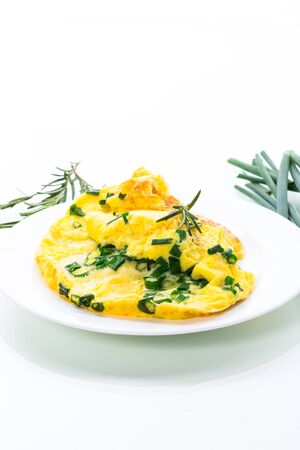 hot fried omelet with chopped green onions in a plate isolated on white backgroundの写真素材