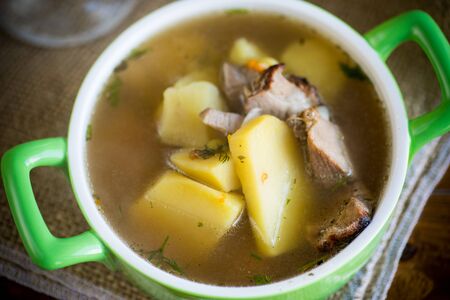 hot pea soup with meat and vegetables in a plateの写真素材
