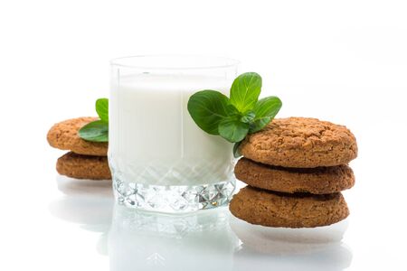 oatmeal cookies with a glass of fresh milk isolated on white backgroundの写真素材