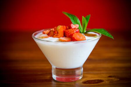 sweet homemade yogurt with red ripe fresh strawberriesの写真素材