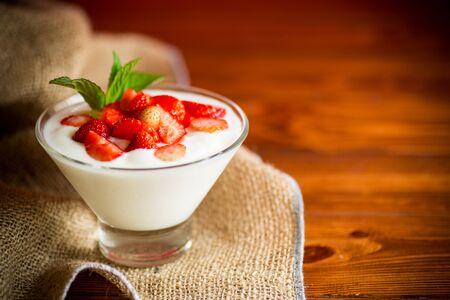sweet homemade yogurt with red ripe fresh strawberriesの写真素材