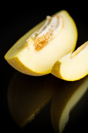 Studio shot of notched ripe melon galia with sliceの写真素材