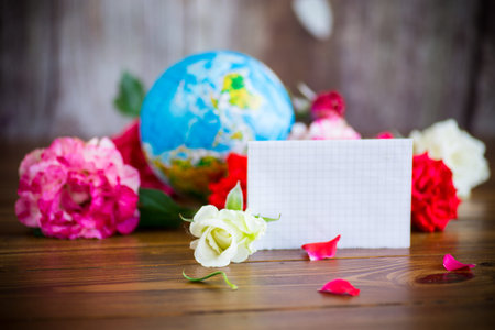 Globe with books and flowers on table