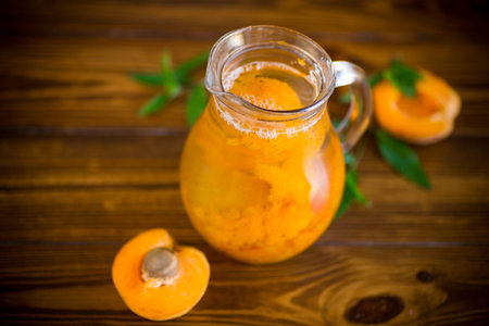 summer cold apricot compote in a glass decanter