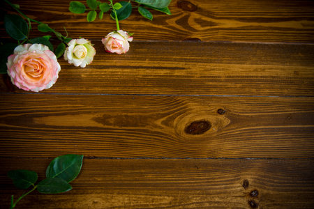 small bouquet of beautiful summer pink roses on a wooden table