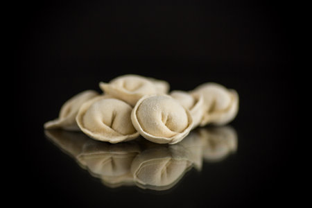 raw homemade dumplings with meat isolated on black backgroundの写真素材