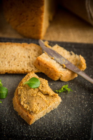 homemade meat pate with homemade bread on a wooden table