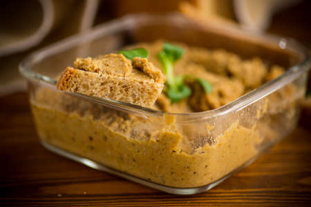 homemade meat pate with homemade bread on a wooden tableの写真素材