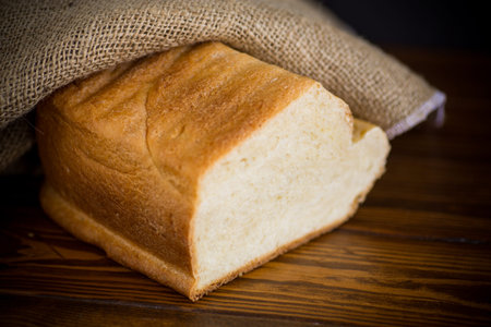 baked homemade bread from a bread machine on a black background