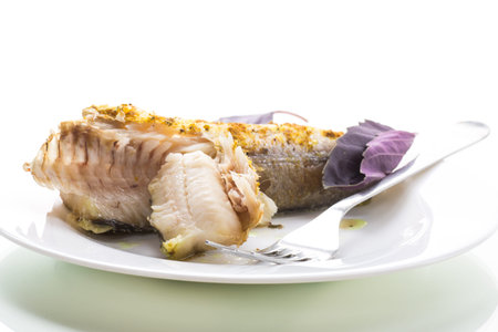 fish baked in the oven with spices, spices isolated on white background