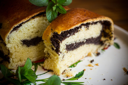 sweet pastries, roll with poppy seeds inside on a wooden table.