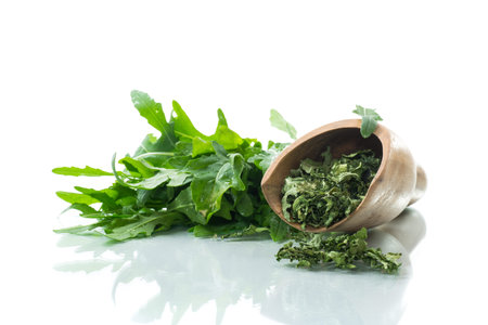 green dried organic arugula, seasoning, isolated on white background.