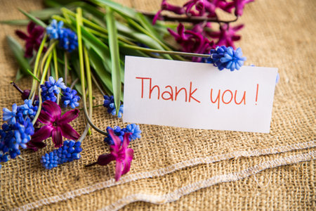 beautiful bouquet of spring flowers on a wooden table, rustic style.の写真素材
