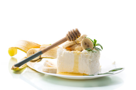 Portion of homemade milk curd with banana slices and honeyの写真素材