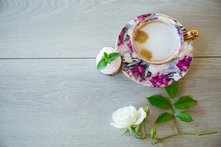 hot natural coffee with milk in a cup on a wooden table