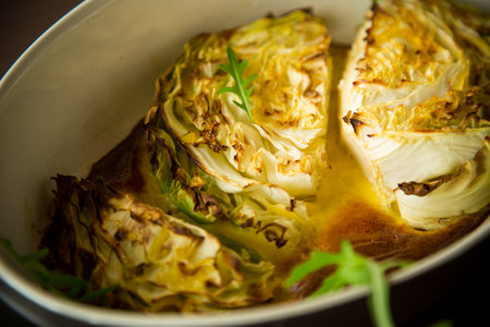 Young early cabbage baked in pieces in the oven, in a ceramic form.の写真素材