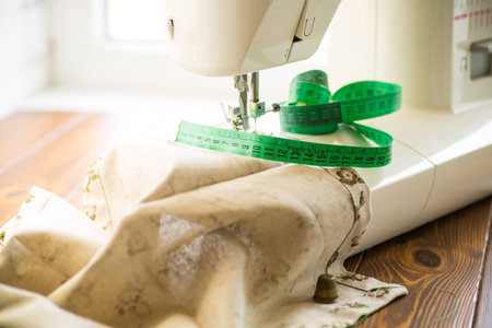 Sewing machine with fabric and threads for sewing, close-up. The working process. Part of a sewing...