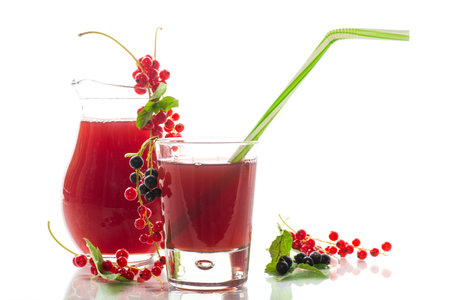 fresh berry juice from red and black currant, isolated on white backgroundの写真素材