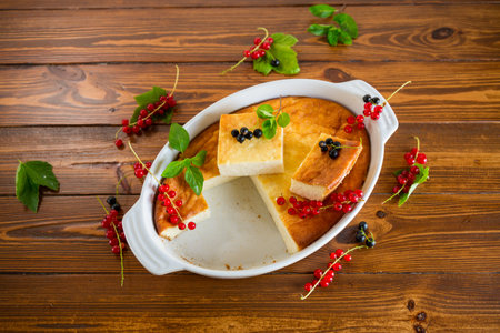 cottage cheese sweet casserole with fresh berries, on a wooden tableの写真素材