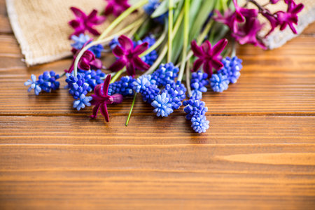 beautiful bouquet of spring flowers on a wooden table, rustic style.の写真素材