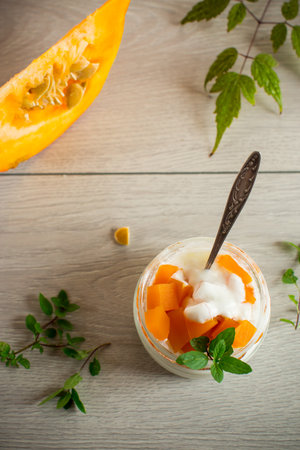 Homemade yogurt with pieces of pumpkin marmalade. Autumn recipes.の写真素材