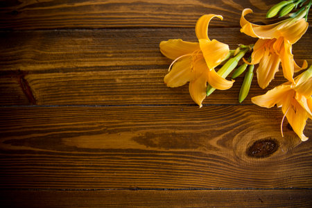 bouquet of beautiful yellow lilies on wooden tableの写真素材