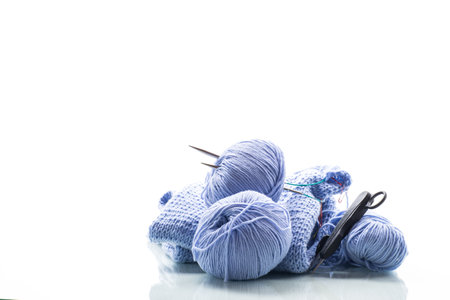 Set for hand knitting, blue yarn, knitting needles and more isolated on a white background.の写真素材
