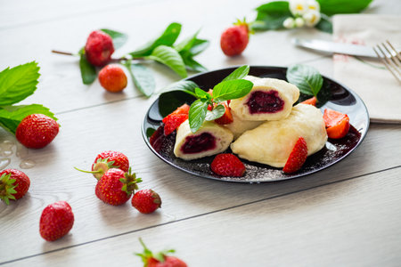 cooked sweet homemade steamed dumplings with strawberries.の写真素材