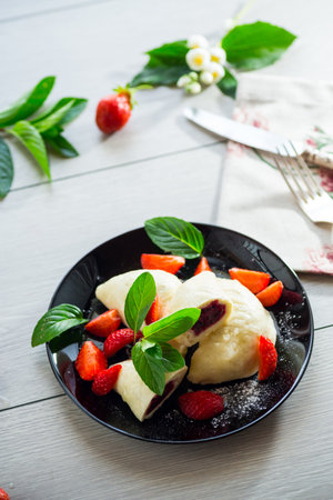 cooked sweet homemade steamed dumplings with strawberries.の写真素材