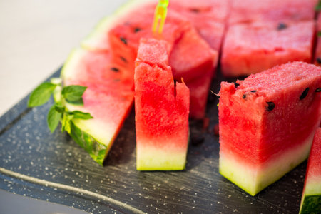 pieces of ripe red watermelon, close-up, on a board.の写真素材