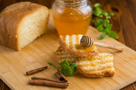 bread fried sweet toasts with honey on wooden board with cinnamon.の写真素材