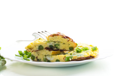 Egg omelette with herbs and vegetables isolated on white background.